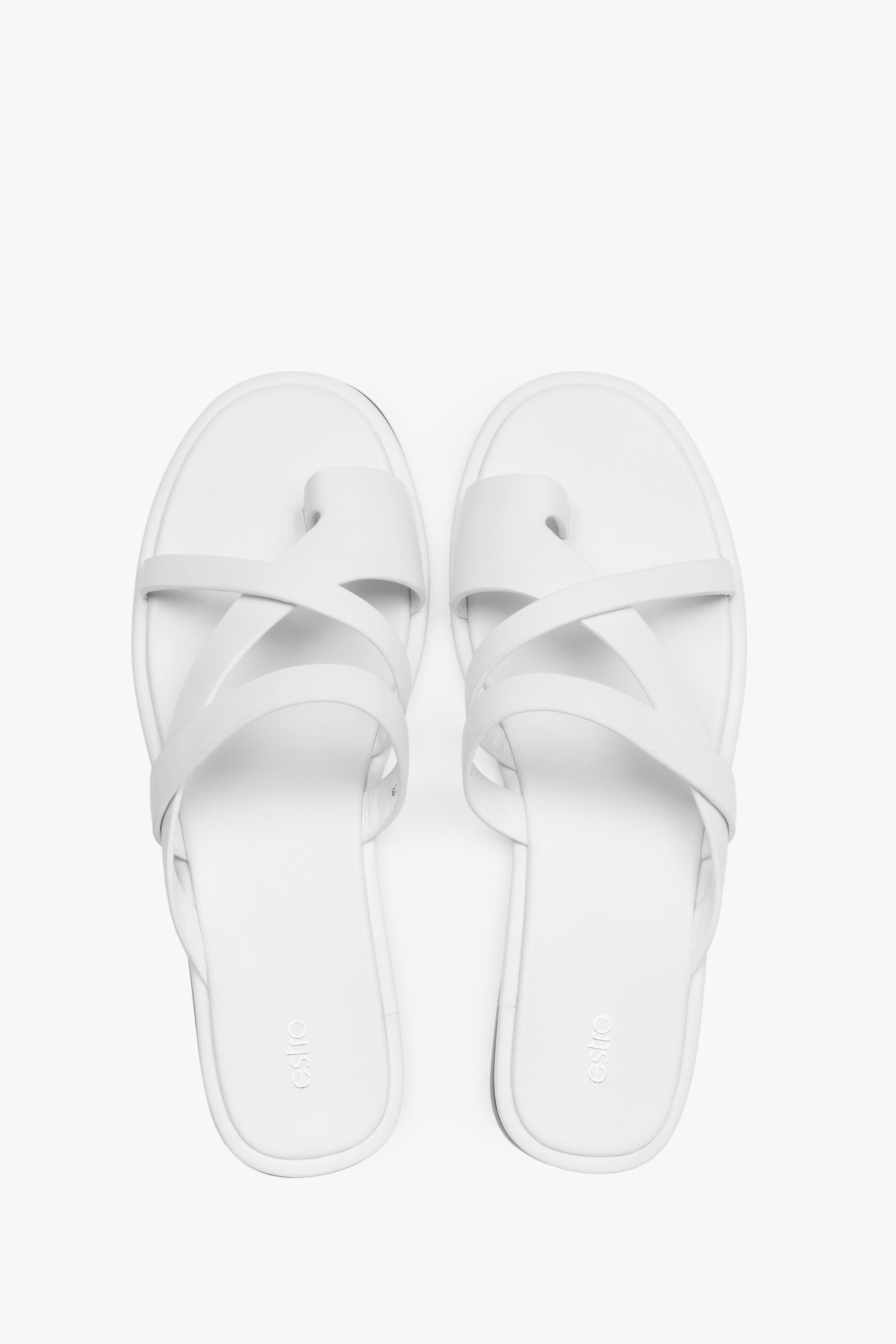 Women's minimalist white leather slide sandals with soft interwoven straps.