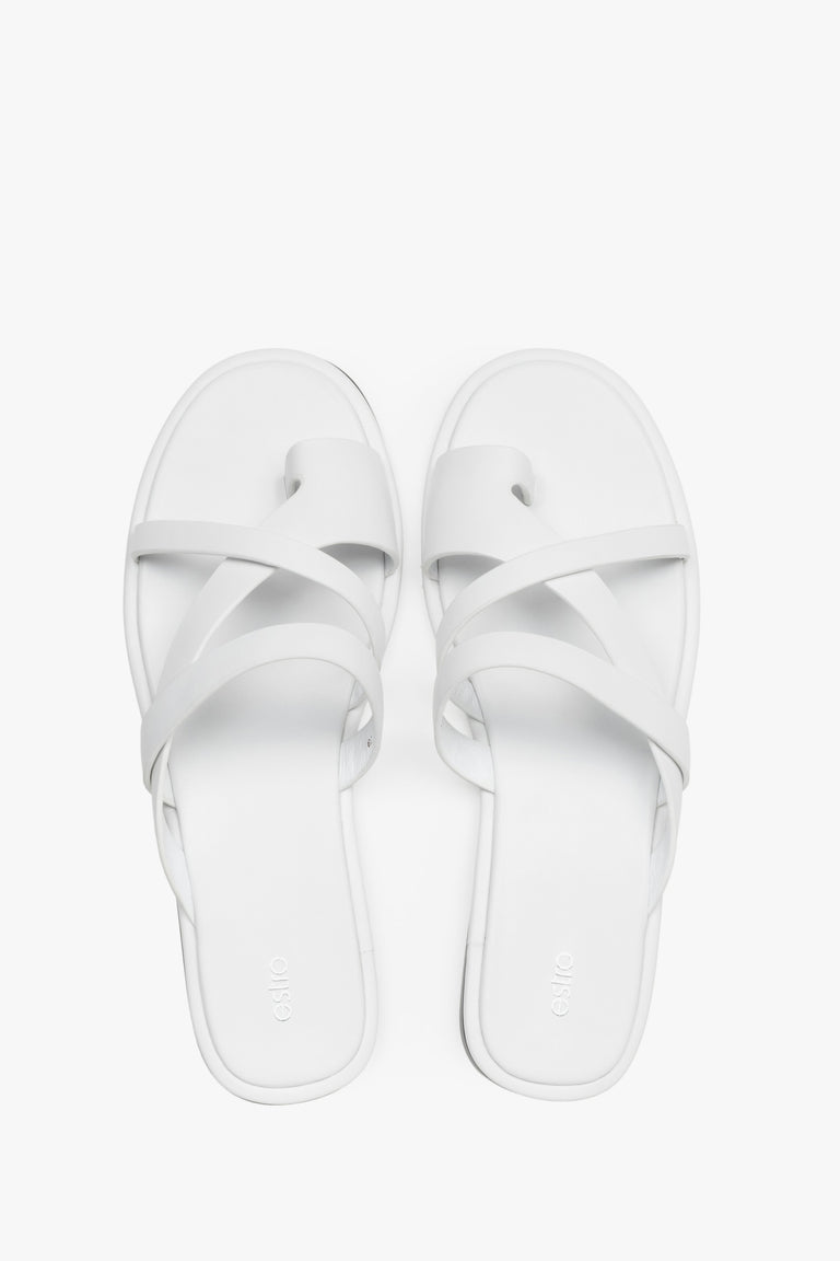 Women's minimalist white leather slide sandals with soft interwoven straps.