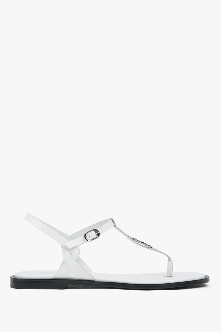 White leather women’s flip-flop sandals with a flat sole.