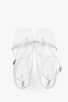 Elegant white sandals with thin straps, made of genuine leather, 7.5 cm heel – top view.