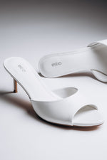 Women's white leather heeled mules by Estro with open toe and open heel.
