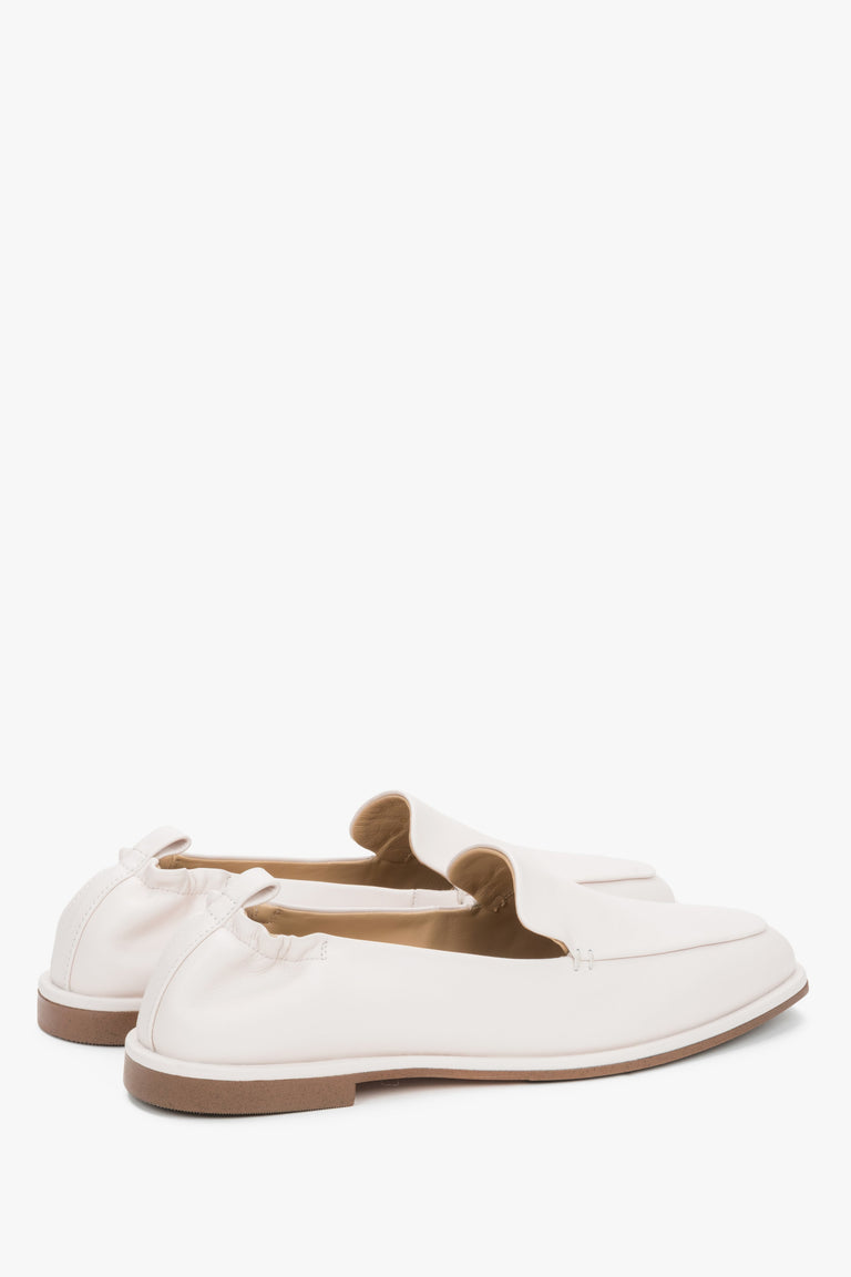 Angled view of women's white leather slip on loafers