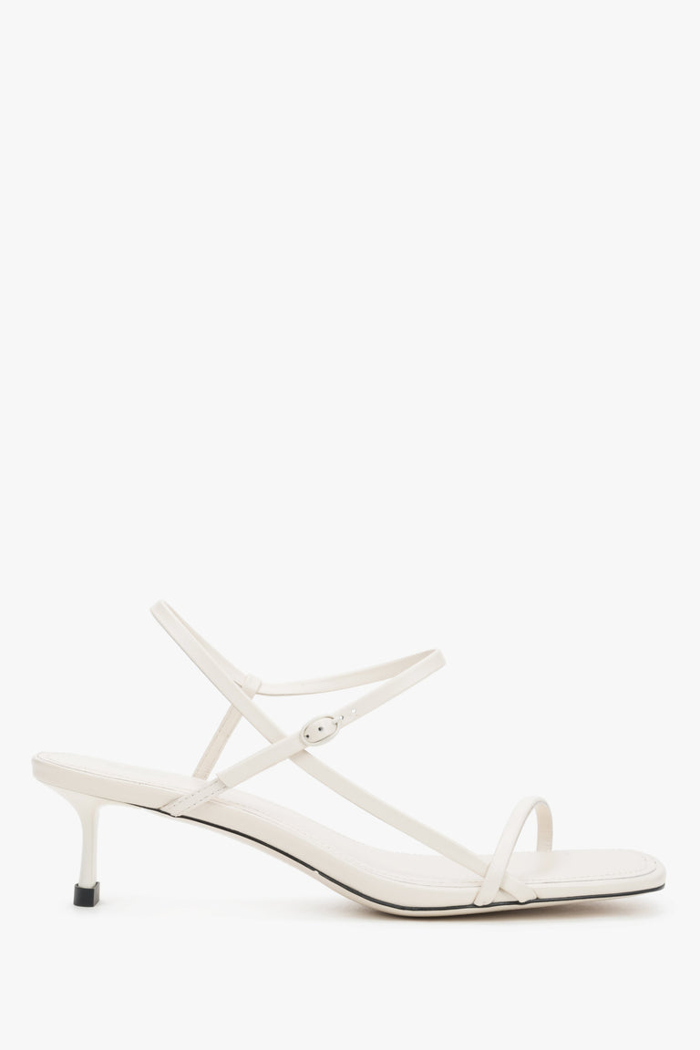 Women’s white leather low-heel sandals thin straps by Estro - side view.