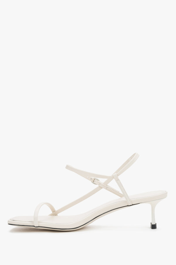 Women’s white leather low-heel sandals made of thin straps by Estro – side view.