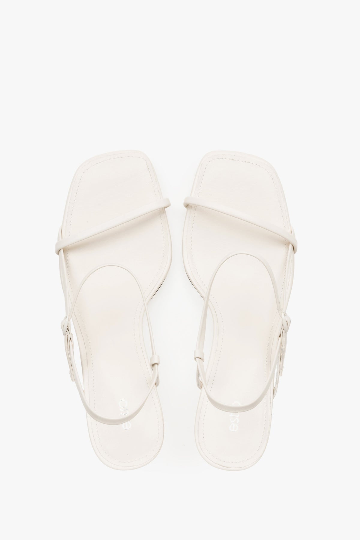 Women’s white low-heel sandals made from genuine leather, featuring thin straps by Estro – top view.