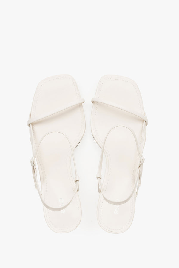 Women’s white low-heel sandals made from genuine leather, featuring thin straps by Estro – top view.