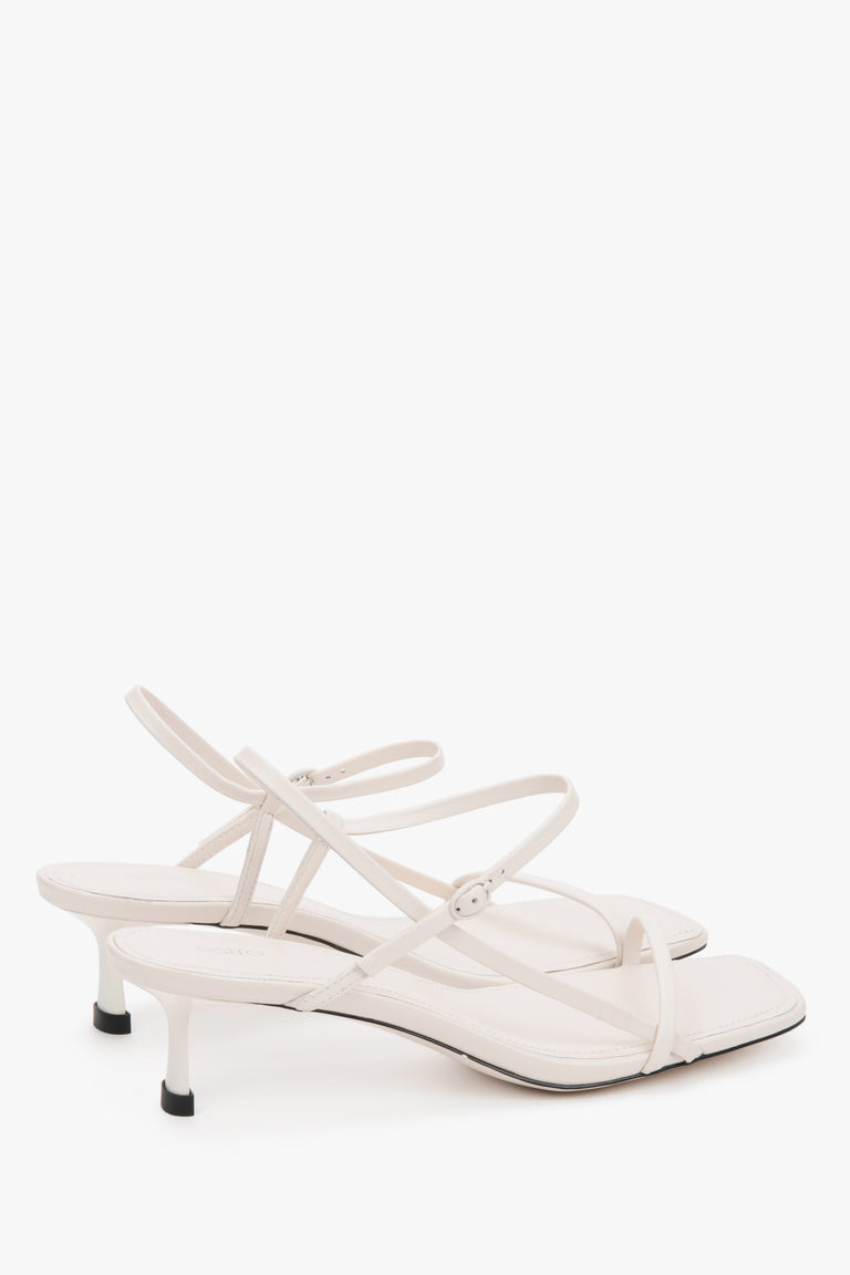 Women’s white leather low-heel sandals thin straps by Estro.
