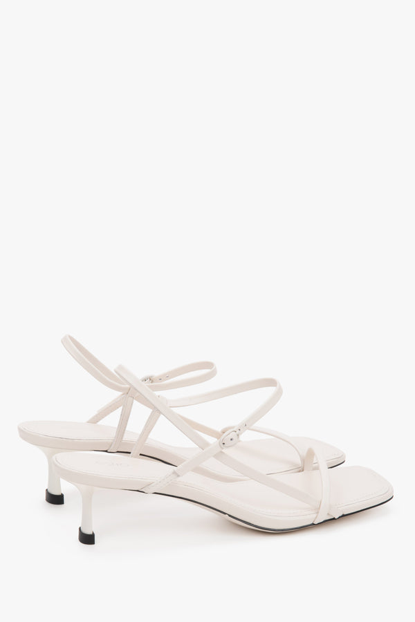 Women’s white leather low-heel sandals thin straps by Estro.