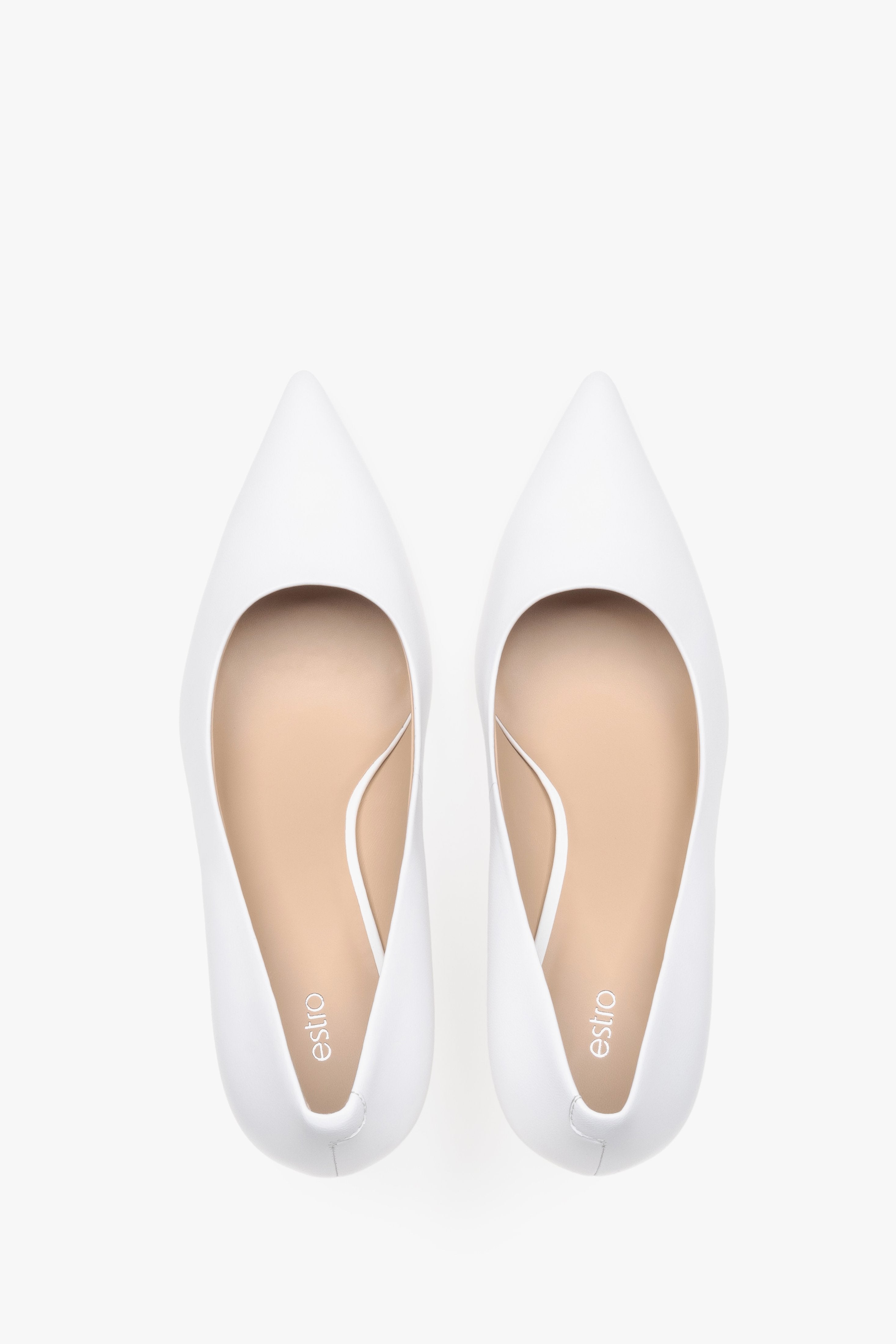 Top view of white leather low-heeled shoes.