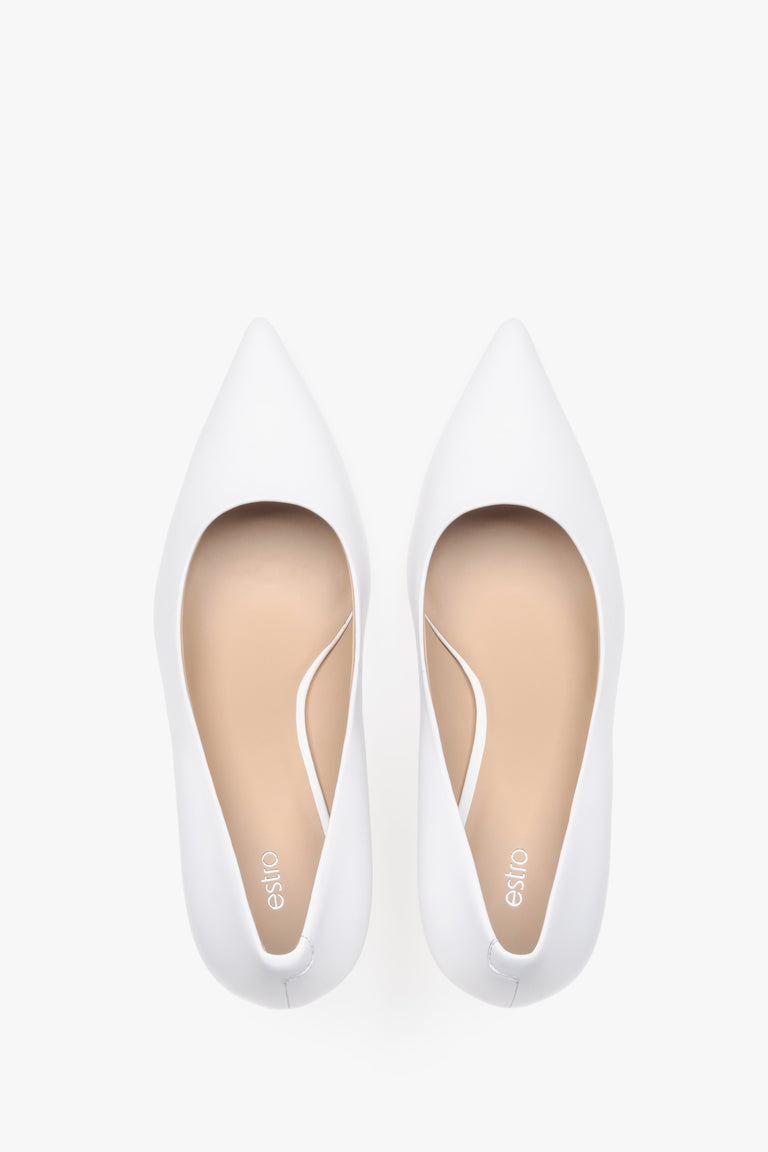 Top view of white leather low-heeled shoes.