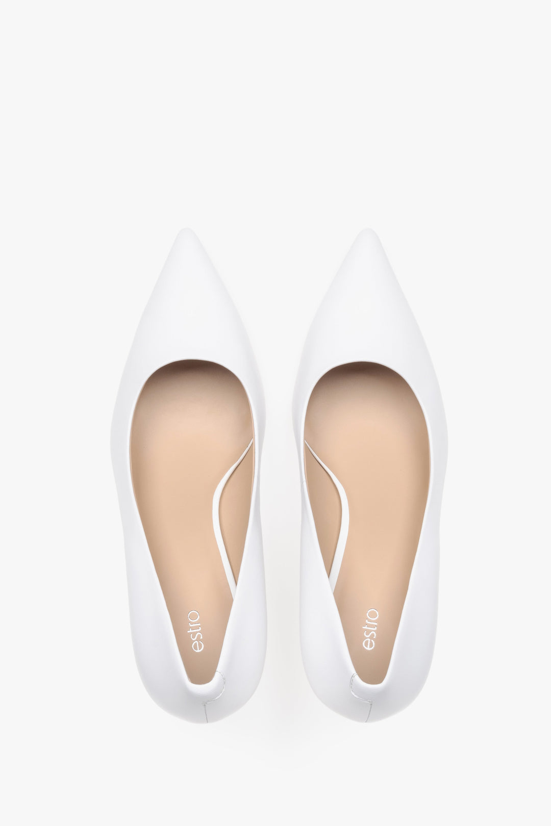 Top view of white leather low-heeled shoes.