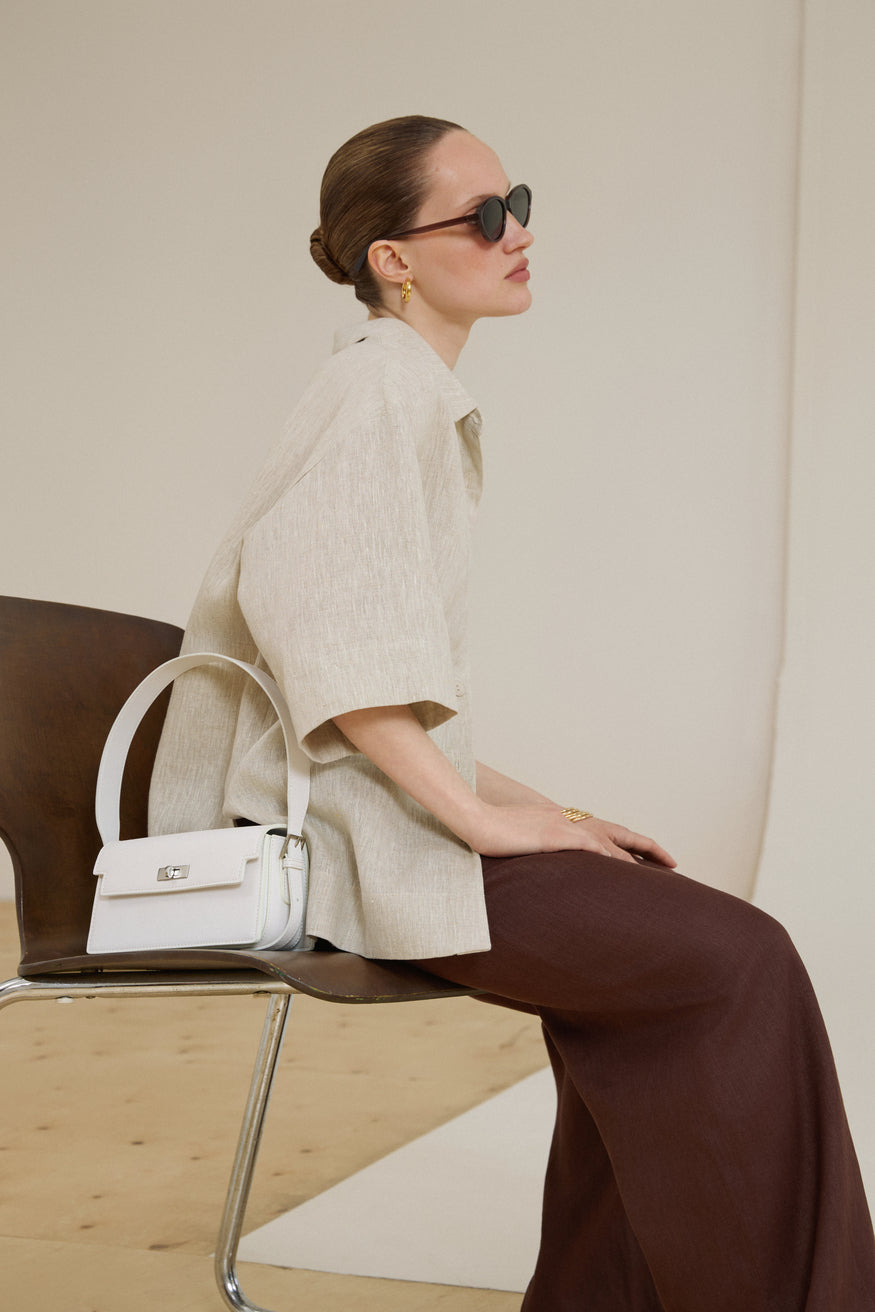 Front view of women's white leather shoulder bag by Estro.