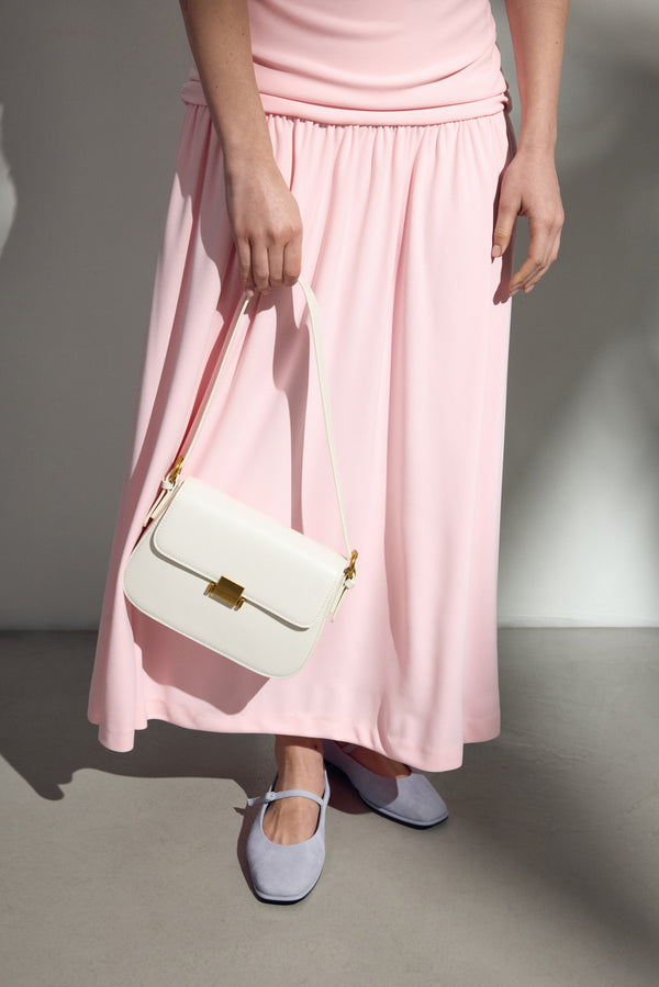 White leather women’s shoulder bag with gold-tone hardware.