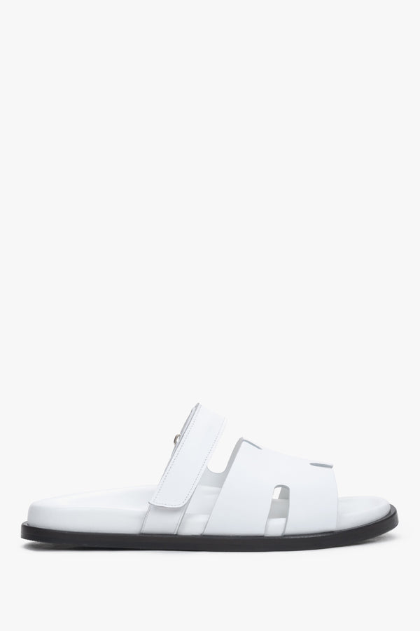 White leather women’s slides with an adjustable strap – side view.