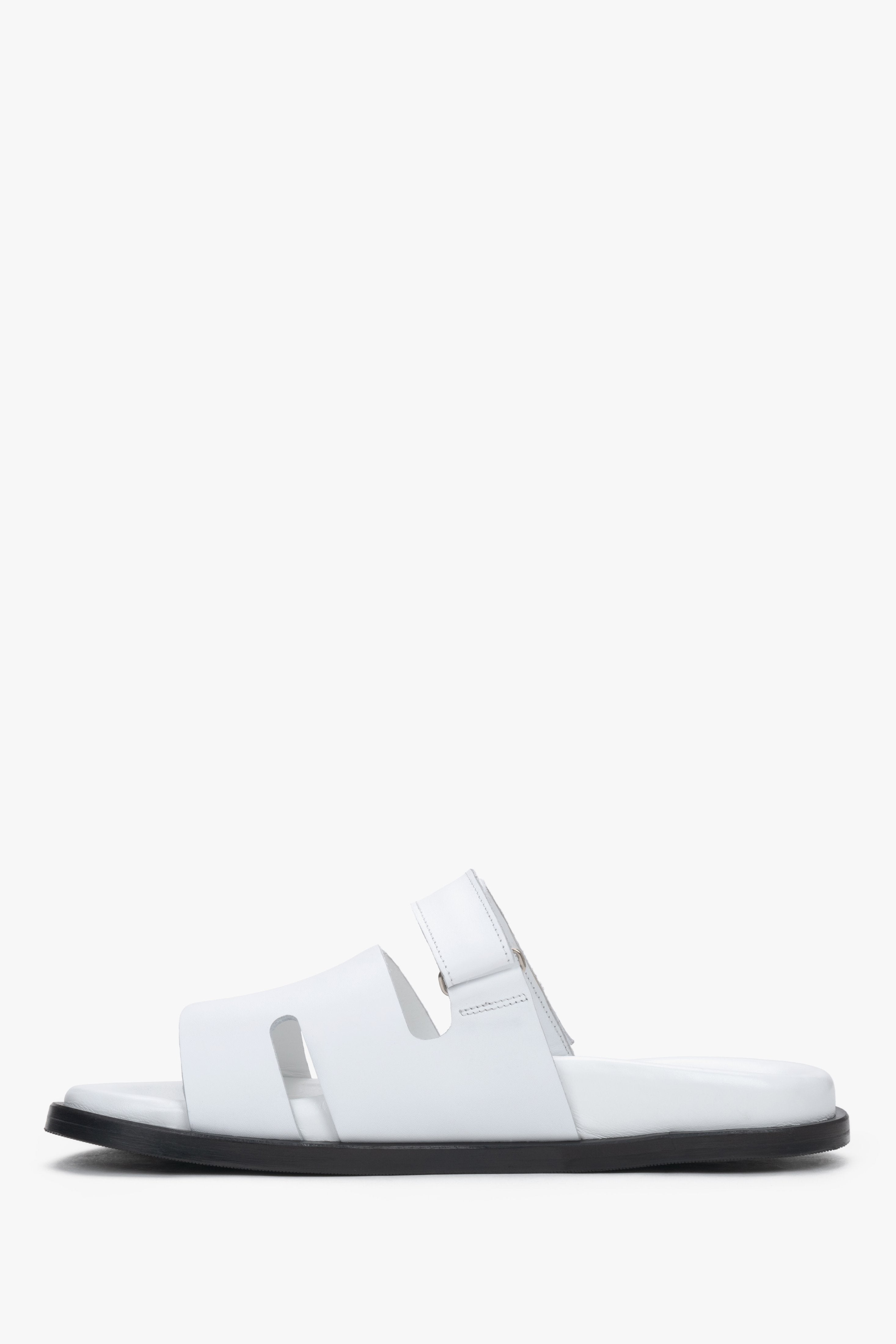 Women’s white leather slides with an adjustable strap by Estro.