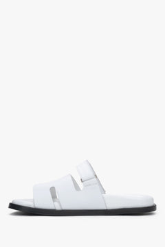 Women’s white leather slides with an adjustable strap by Estro.