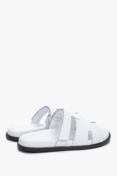 Women’s white leather slides with an adjustable strap by Estro – heel view.