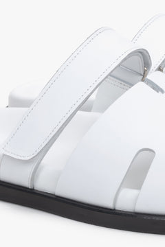 Women’s white leather slides by Estro with an adjustable strap – details.