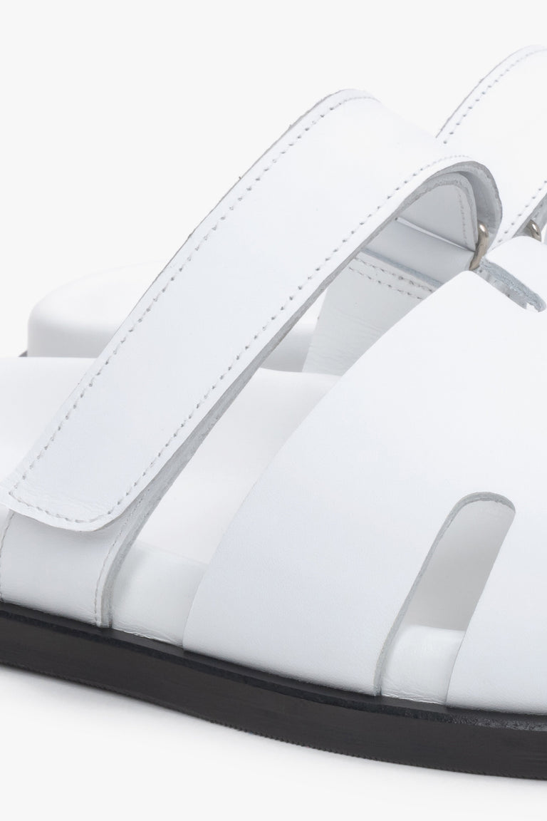 Women’s white leather slides by Estro with an adjustable strap – details.
