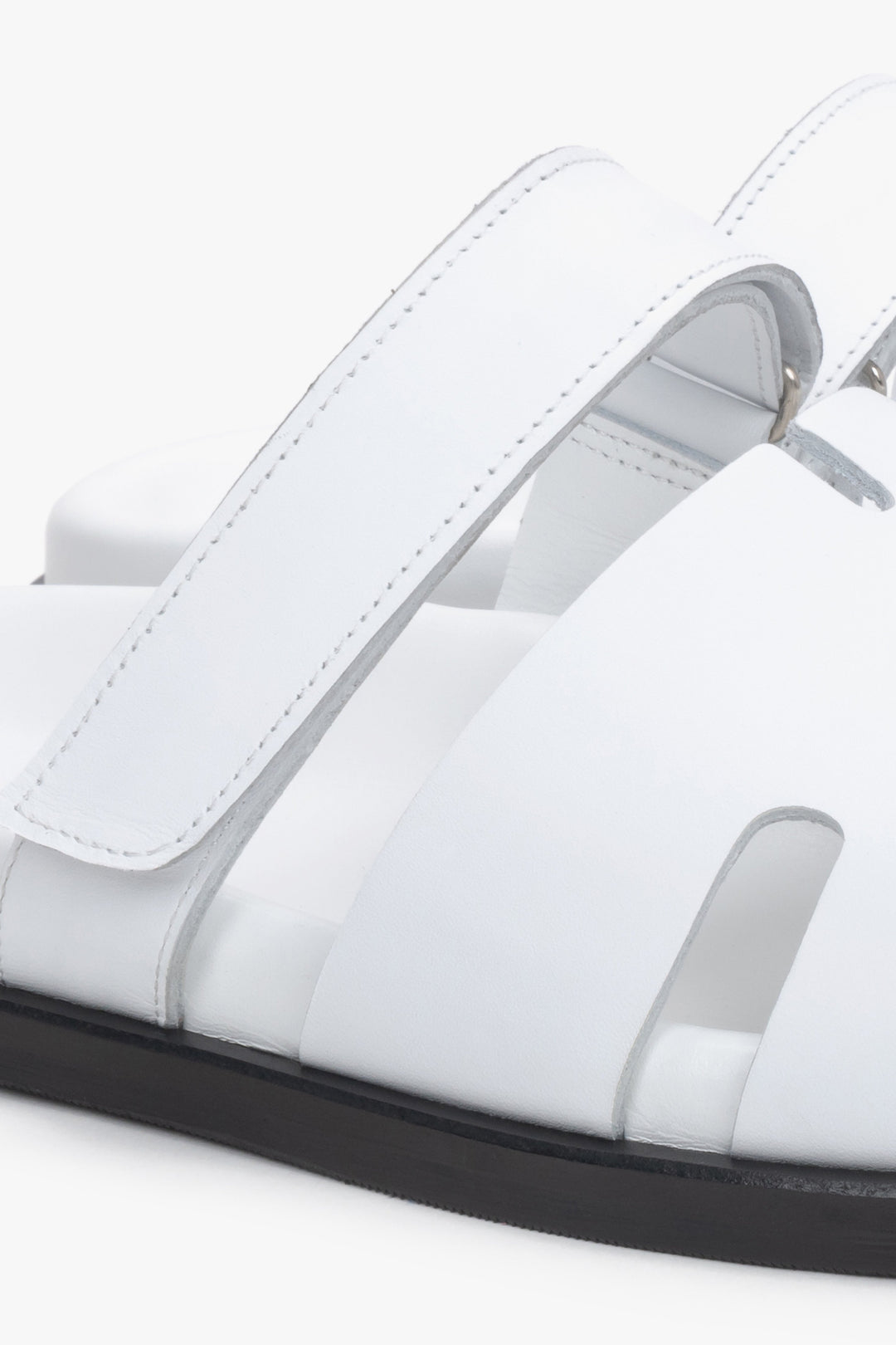 Women’s white leather slides by Estro with an adjustable strap – details.