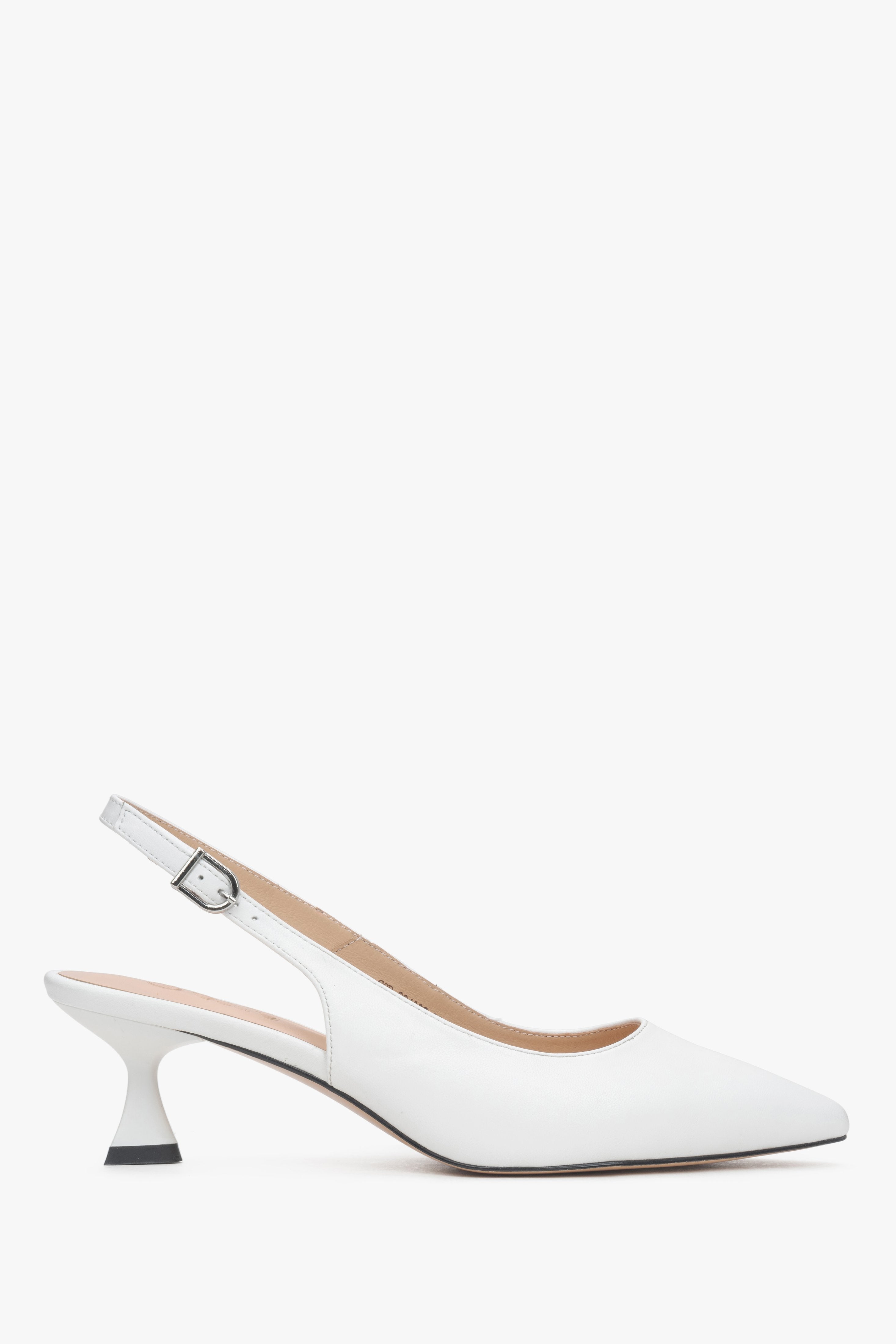 Women’s white leather slingback pumps with a low flared heel.
