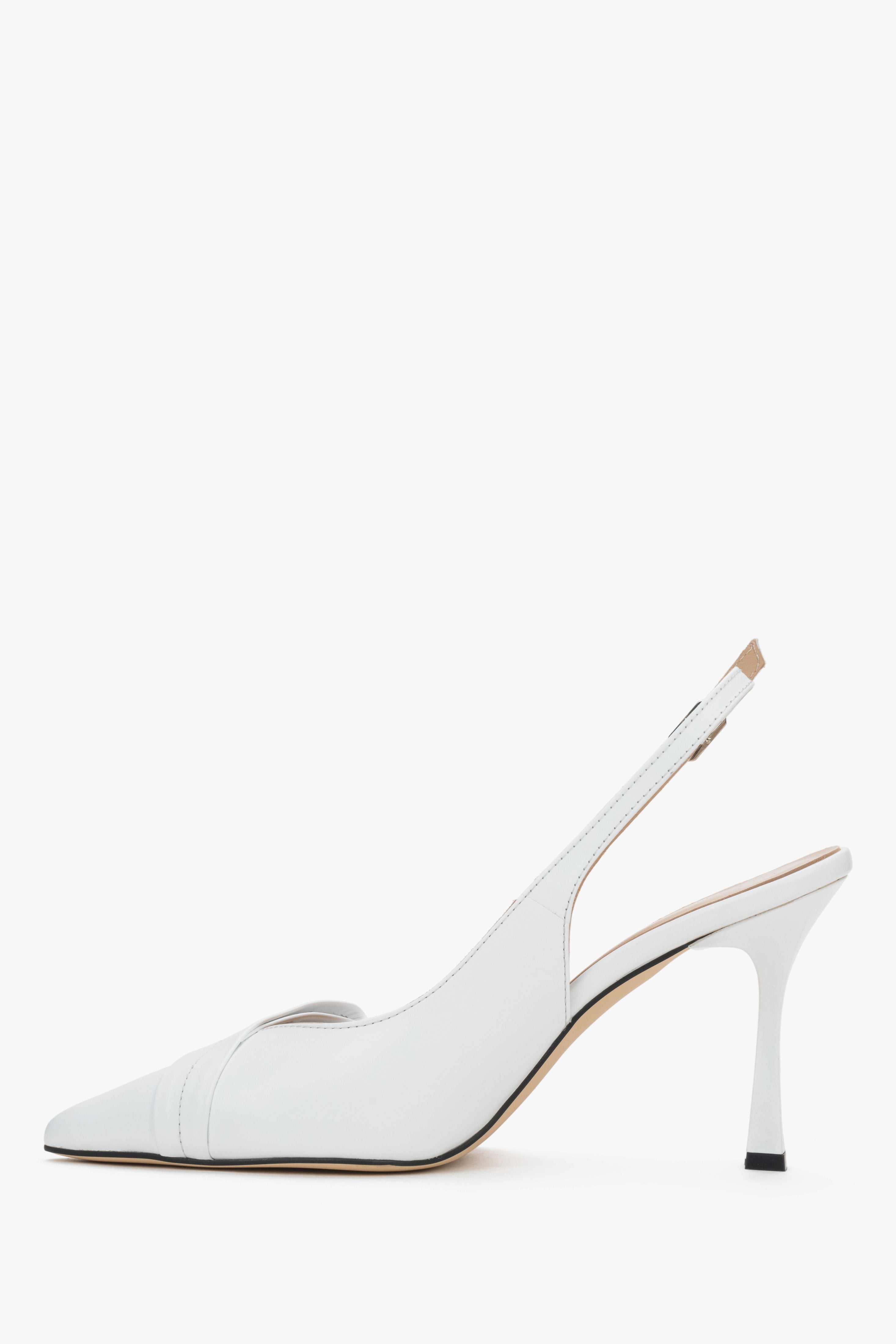 Elegant white women's shoes showcasing a beautifully contoured arch line and a subtle metal buckle at the fastening.
