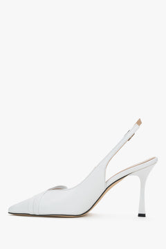 Elegant white women's shoes showcasing a beautifully contoured arch line and a subtle metal buckle at the fastening.