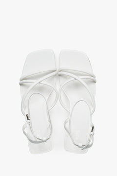 Top view of women's white leather stiletto sandals by Estro.