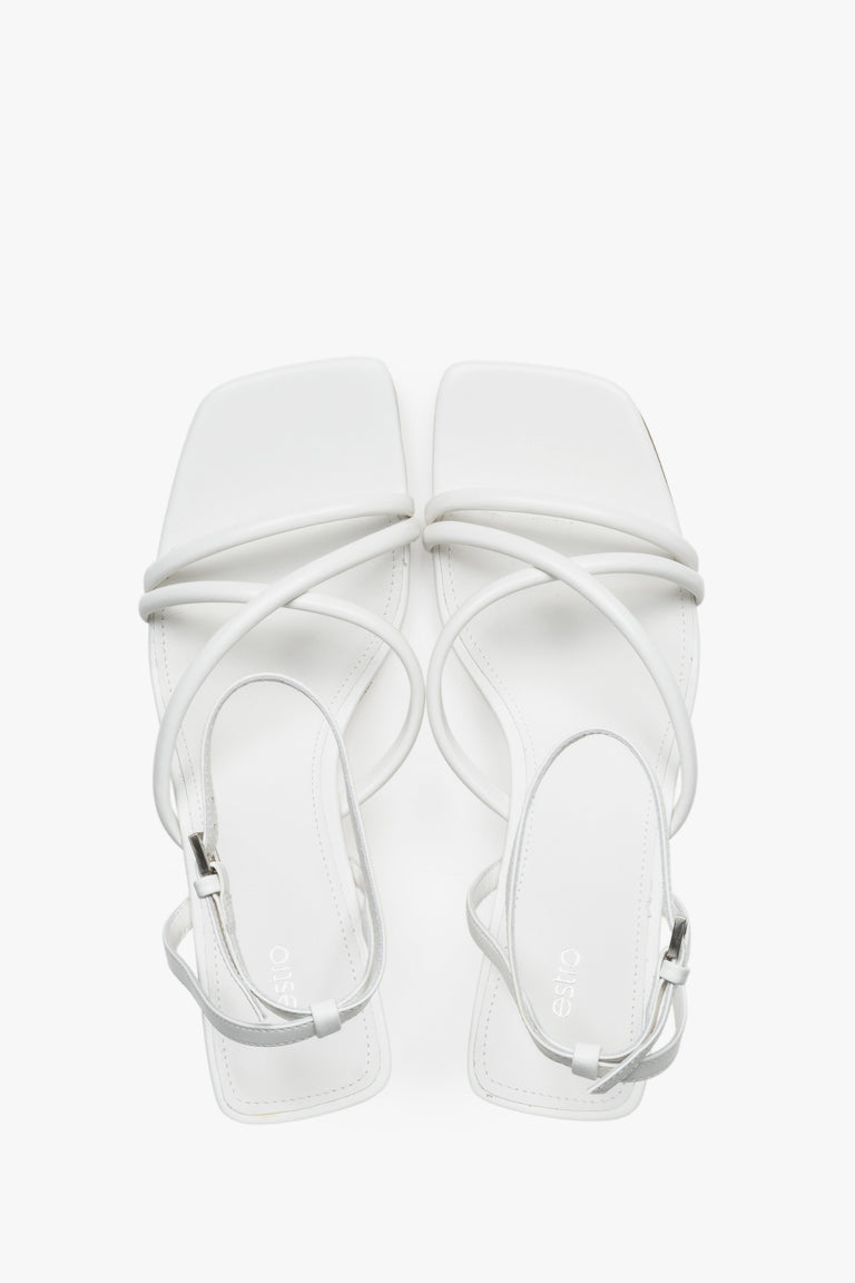 Top view of women's white leather stiletto sandals by Estro.