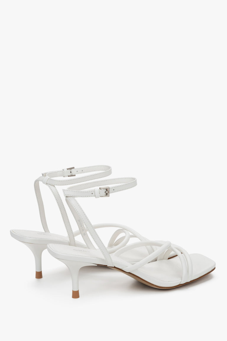 Detail view of soft crossing straps on white leather Estro sandals.