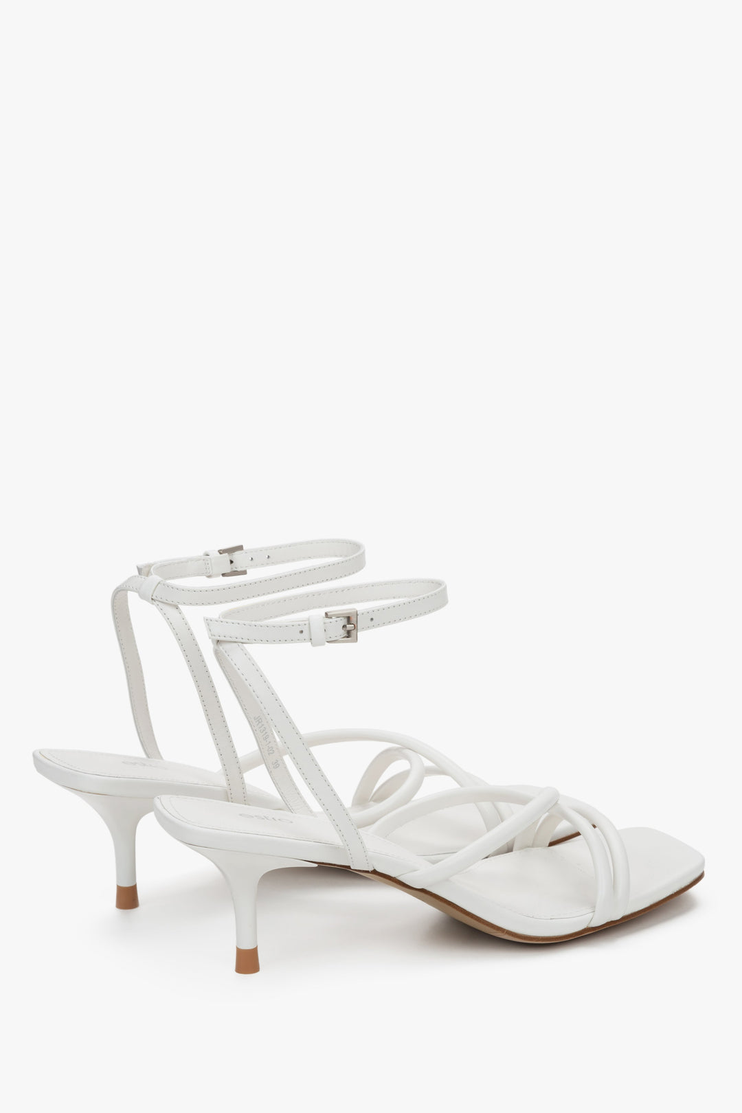 Detail view of soft crossing straps on white leather Estro sandals.