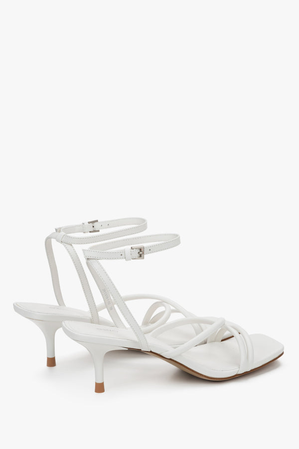 Detail view of soft crossing straps on white leather Estro sandals.