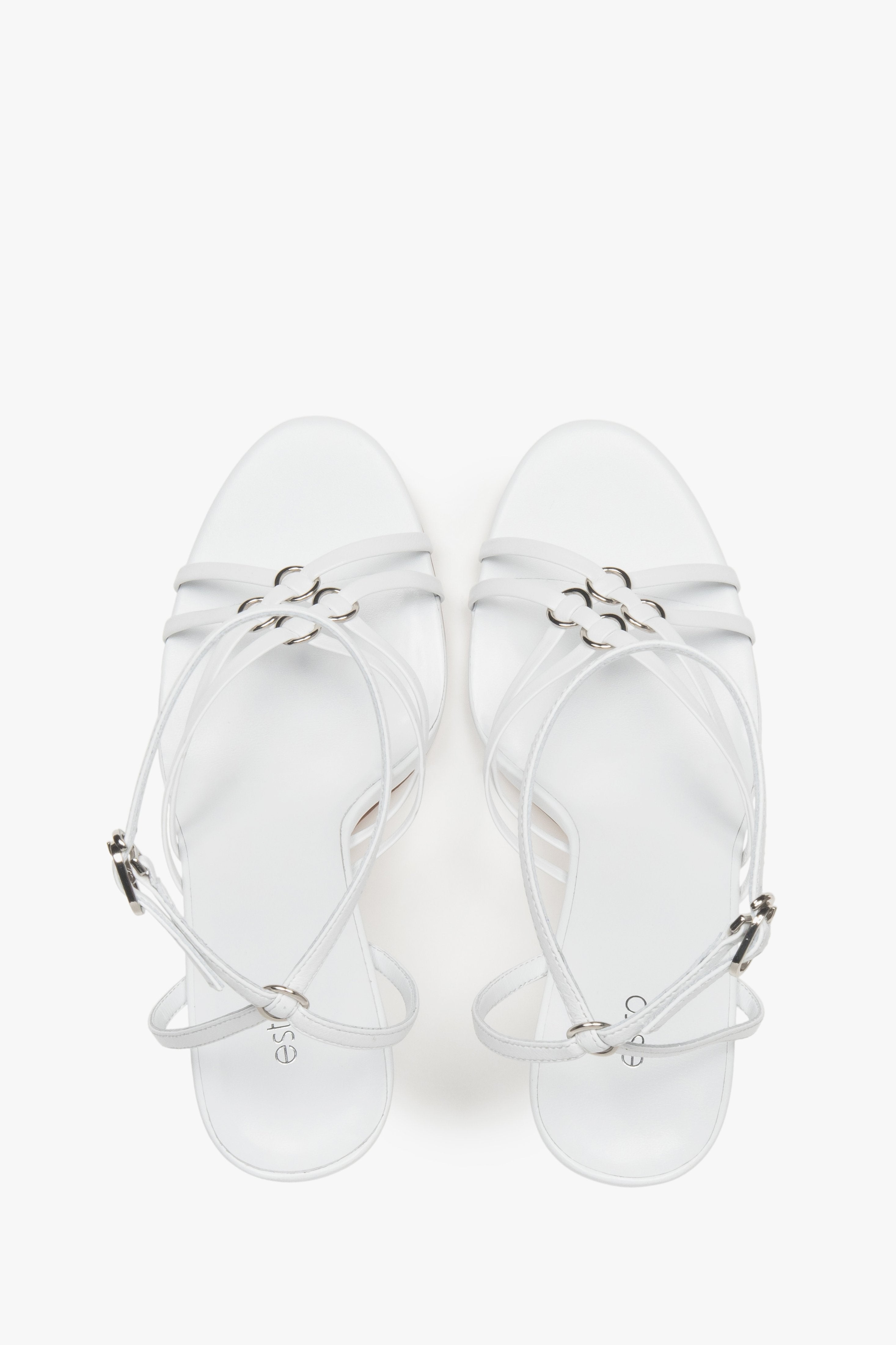 Women’s white leather stiletto sandals with silver details by Estro.