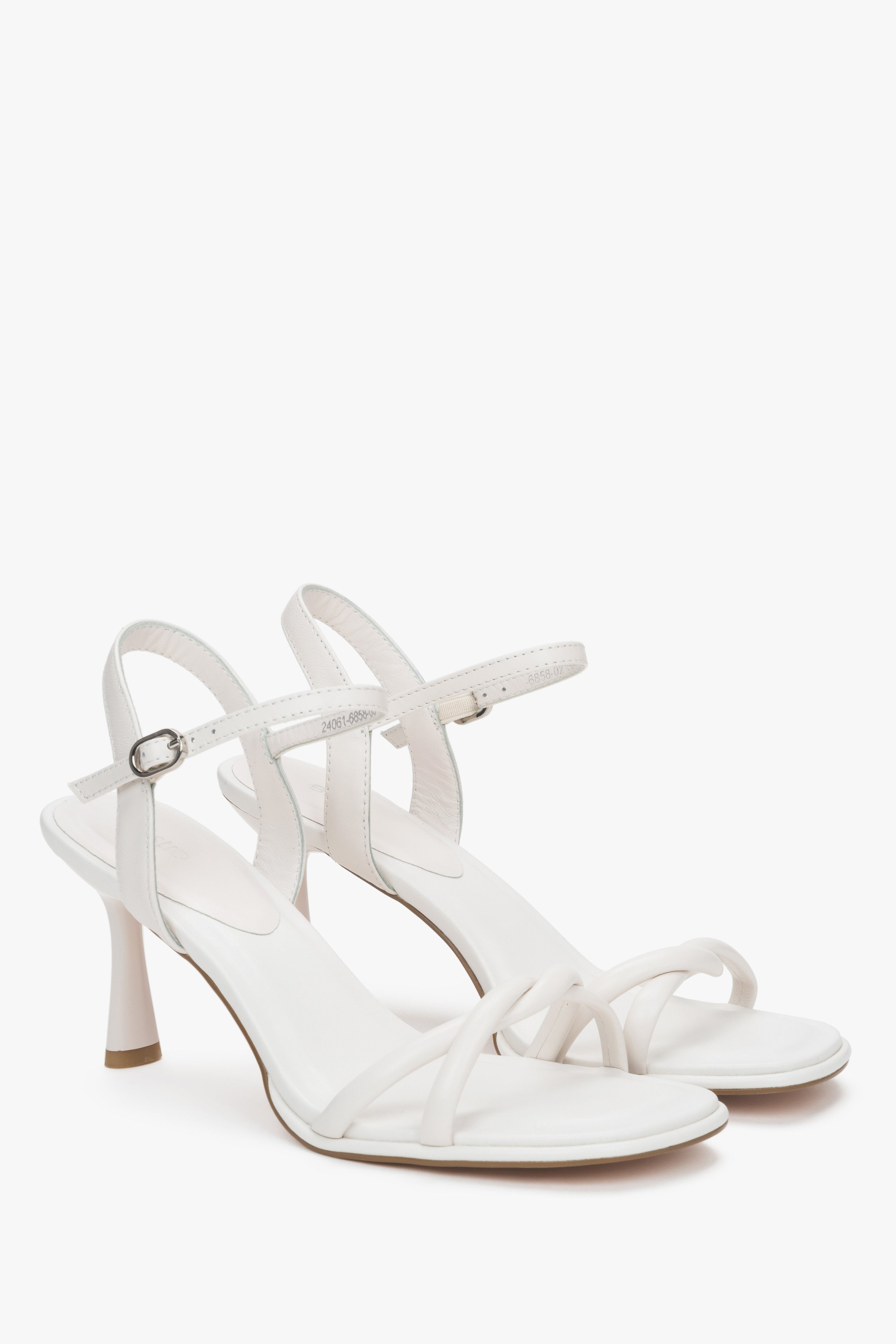 White women’s leather stiletto sandals with thin straps.