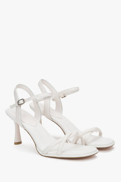 White women’s leather stiletto sandals with thin straps.
