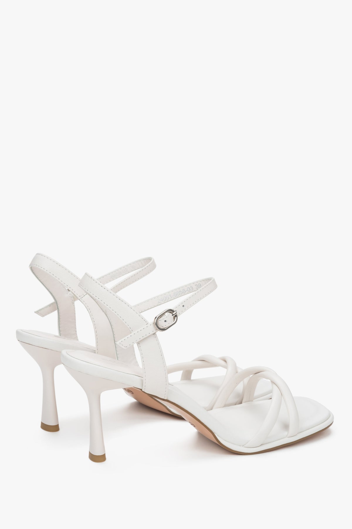 With a stiletto heel, white women’s leather sandals with thin straps by Estro.