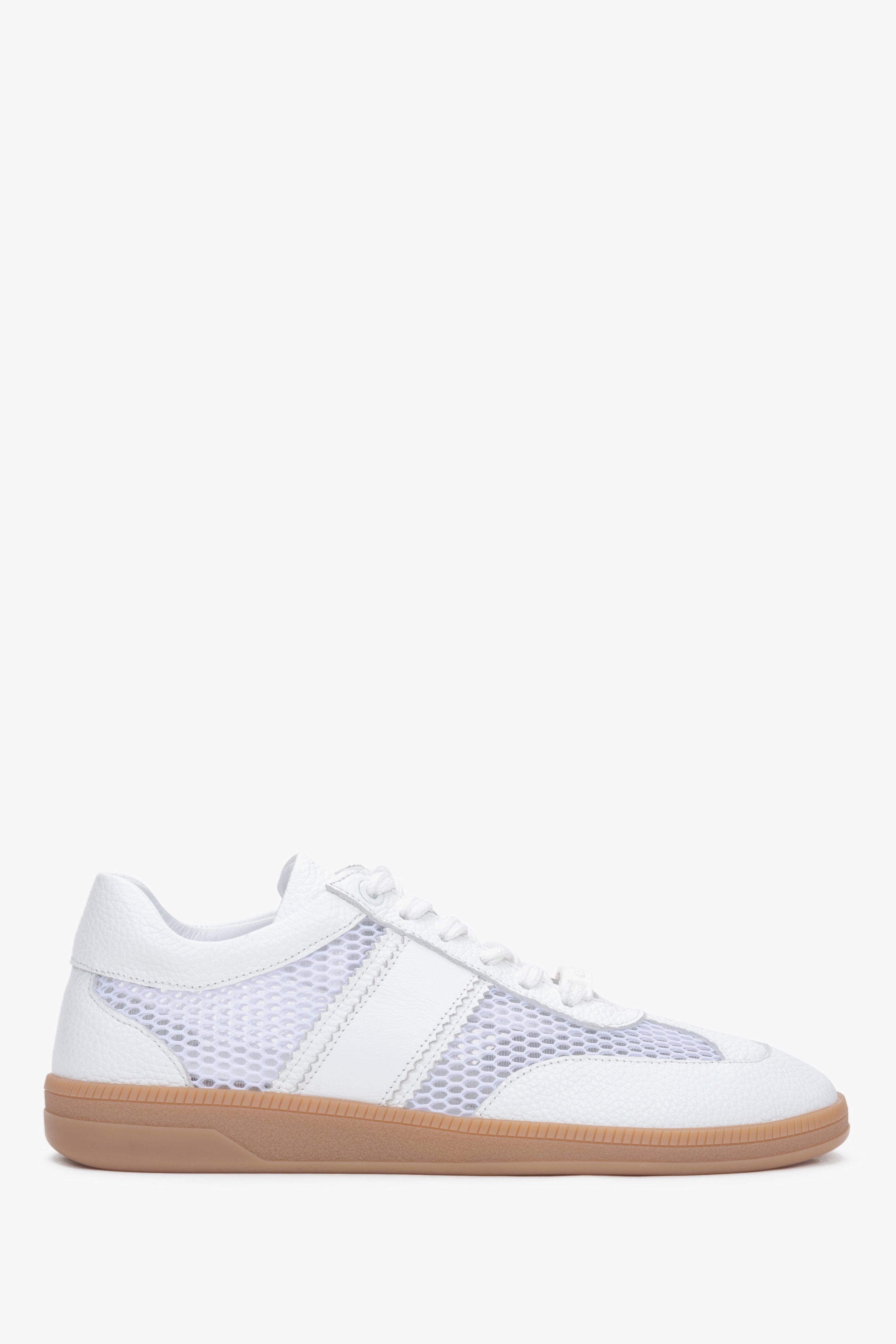 Side profile of white leather and mesh sneakers.