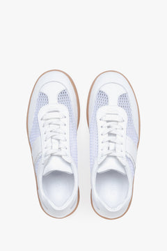 View from above of white sneakers with mesh details.