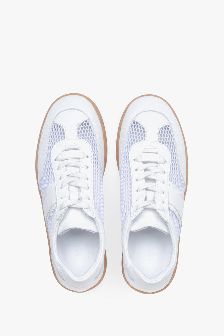 View from above of white sneakers with mesh details.