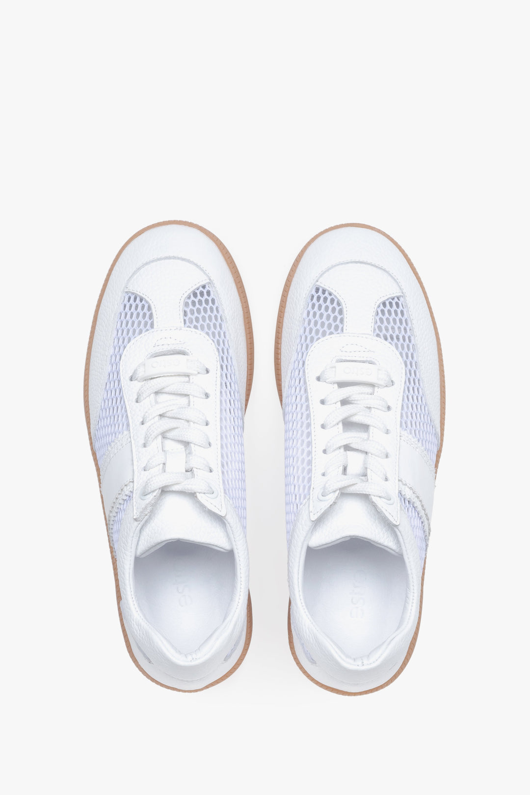 View from above of white sneakers with mesh details.