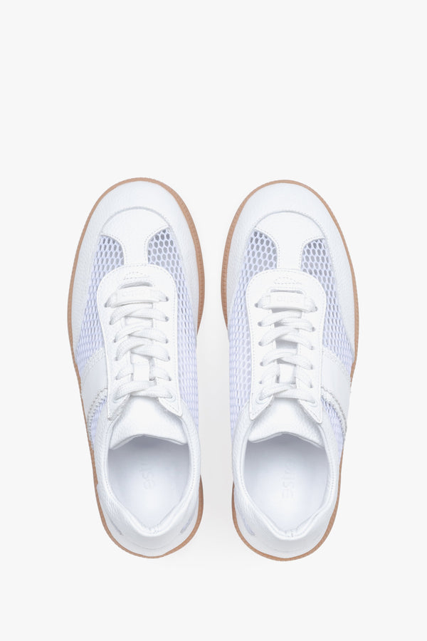 View from above of white sneakers with mesh details.