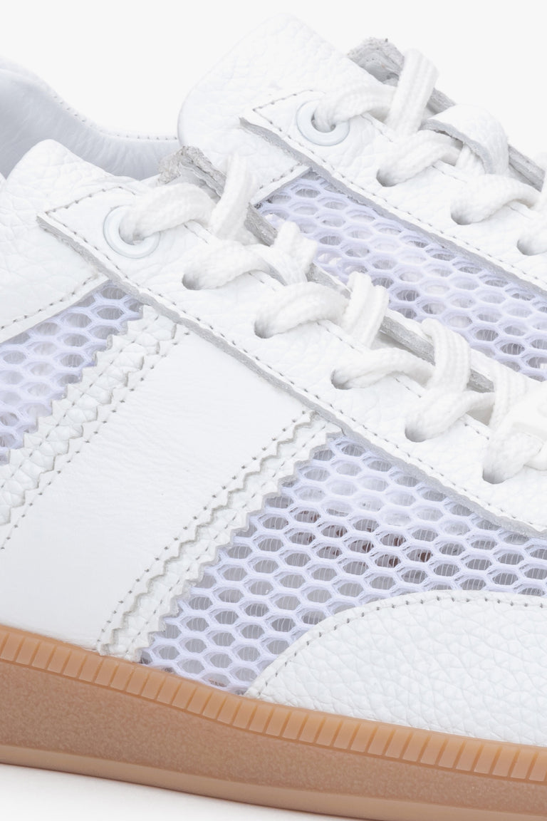 Close-up of white natural leather, velour, and mesh sneakers.