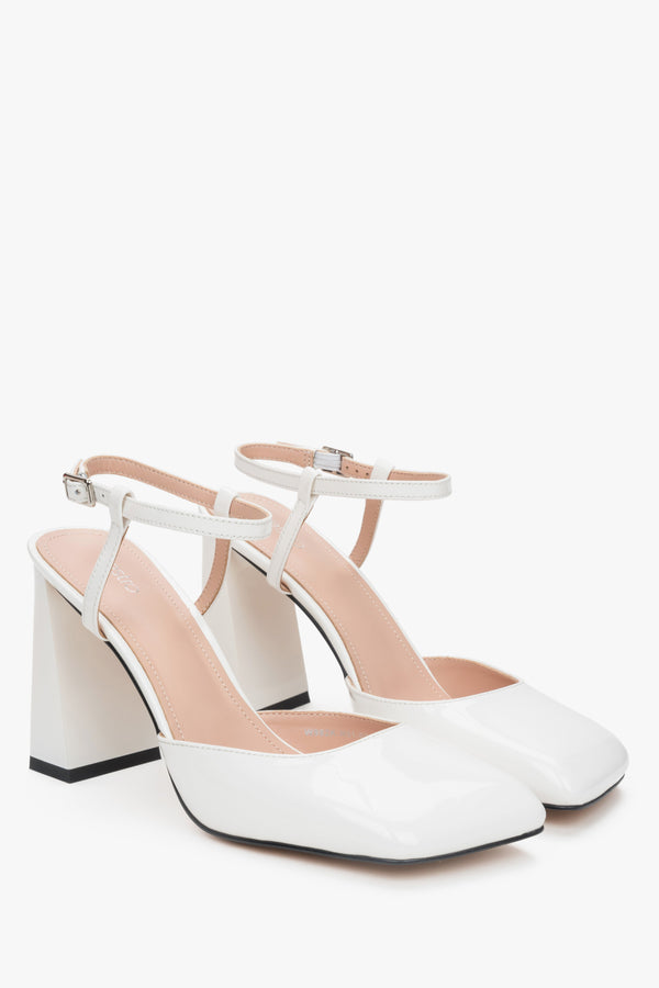 Women’s white block heel sandals in patent leather.