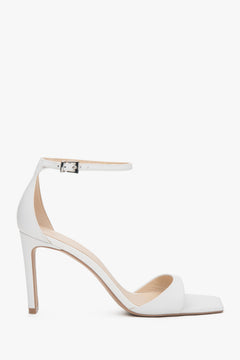 Women’s white sandals in patent natural leather on a stable block heel.