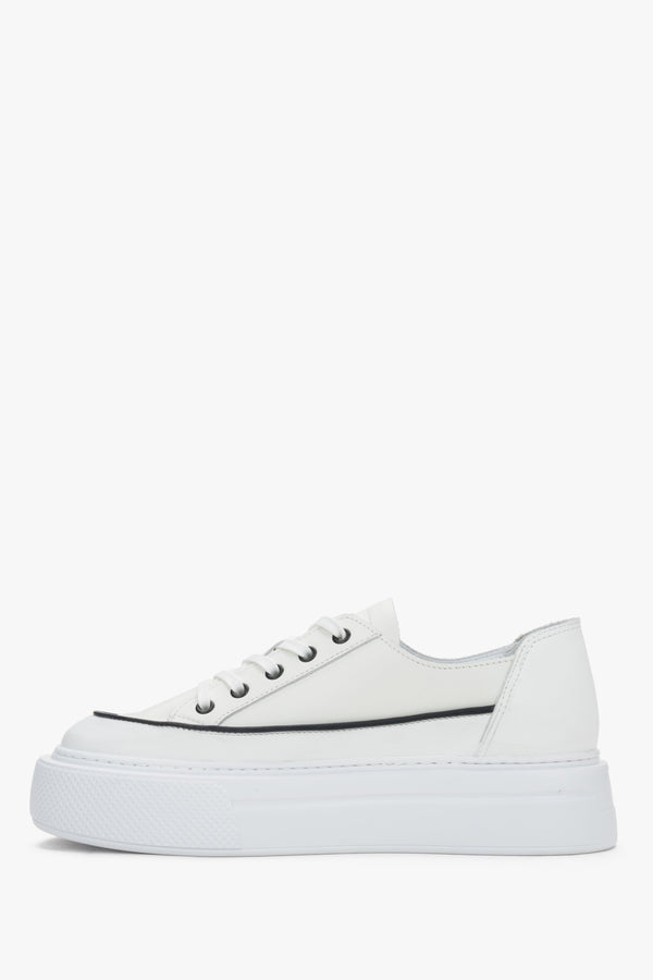 Side view of women’s white leather platform sneakers with lace-up fastening.