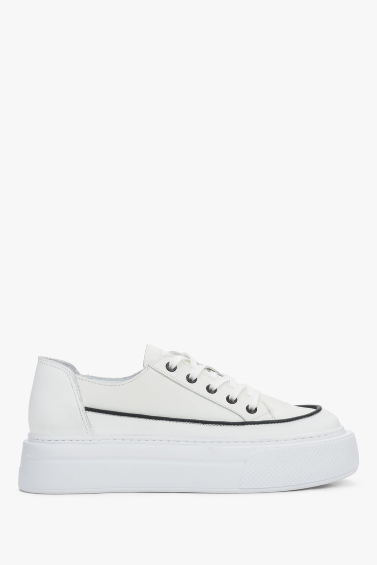 Side view of women's white leather platform sneakers with lace-up closure.