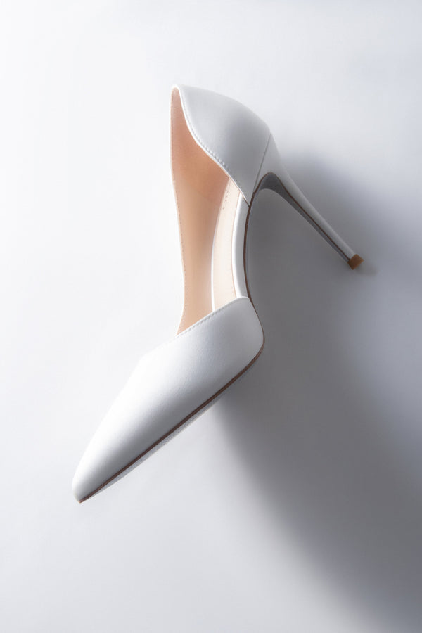 Women’s white high stiletto heels with a satin finish.