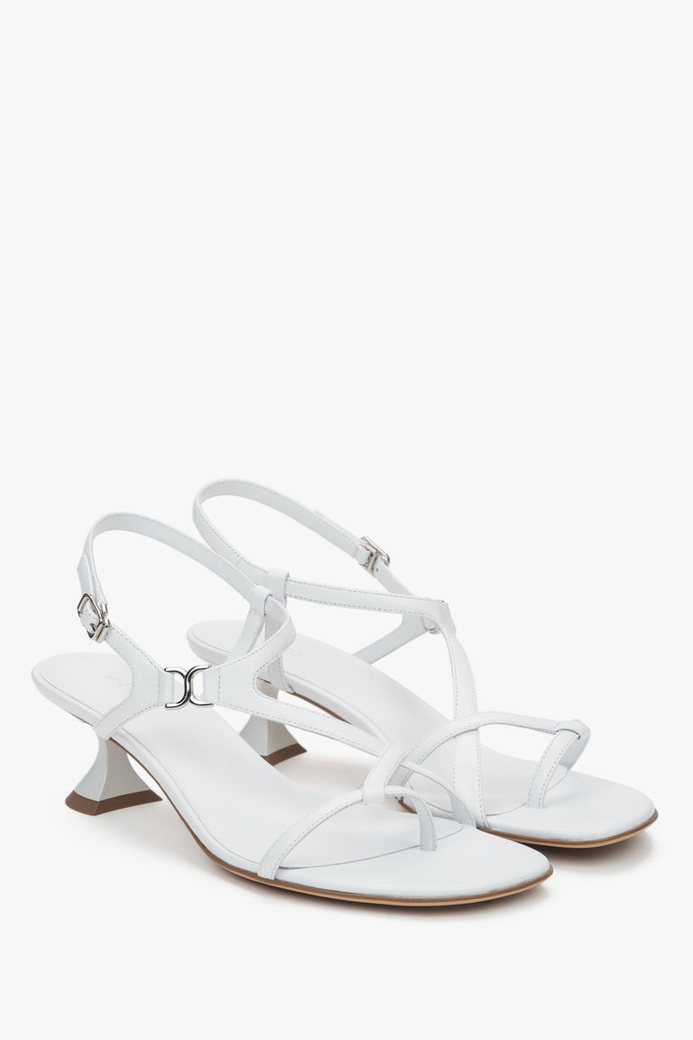 White women’s sandals with a funnel heel and woven straps.