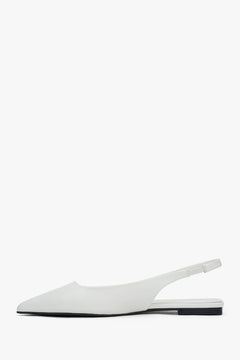 White flat slingback sandals with a pointed toe.