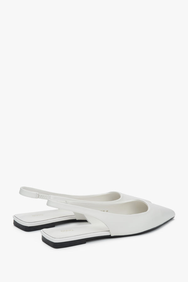 White slingback sandals with a pointed toe and flat heel.